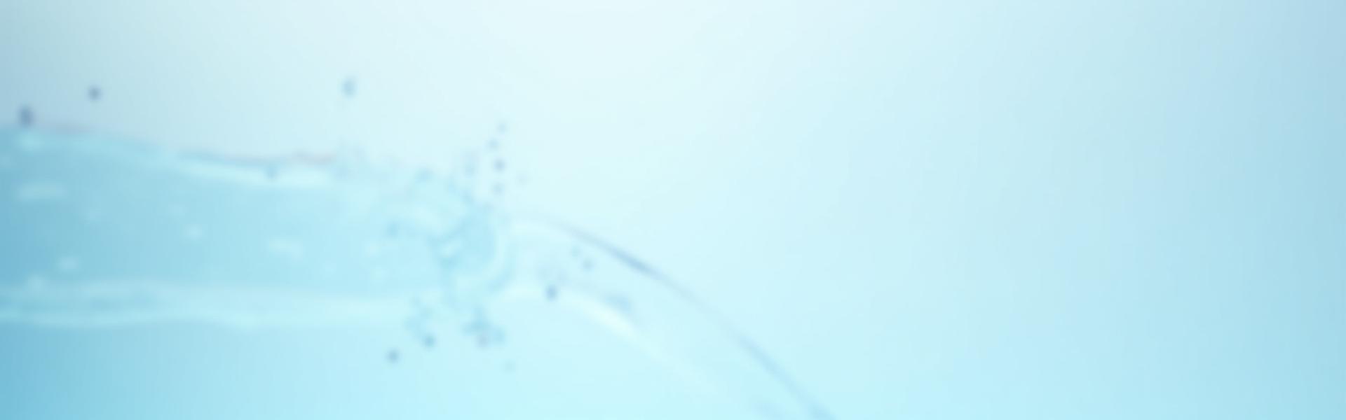 Clean water flowing smoothly through a transparent pipe with a blurred background